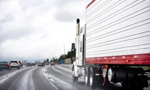 A truck driving moving down a highway