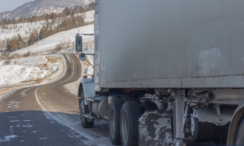 A truck driving down a road with no traffic