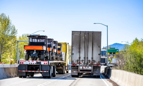 Multiple freight trucks on a highway