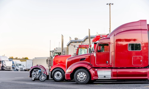 Multiple freight trucks in a parking lot