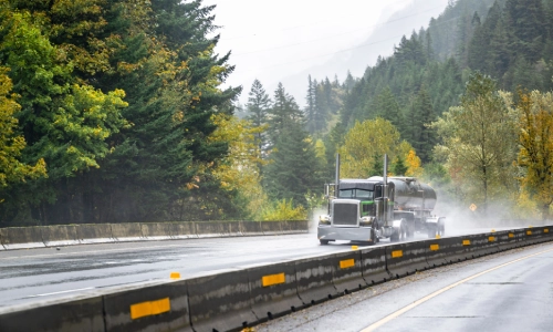 A fast freight truck on a wet road